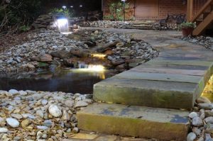 waterfall in yard, landscape lighting